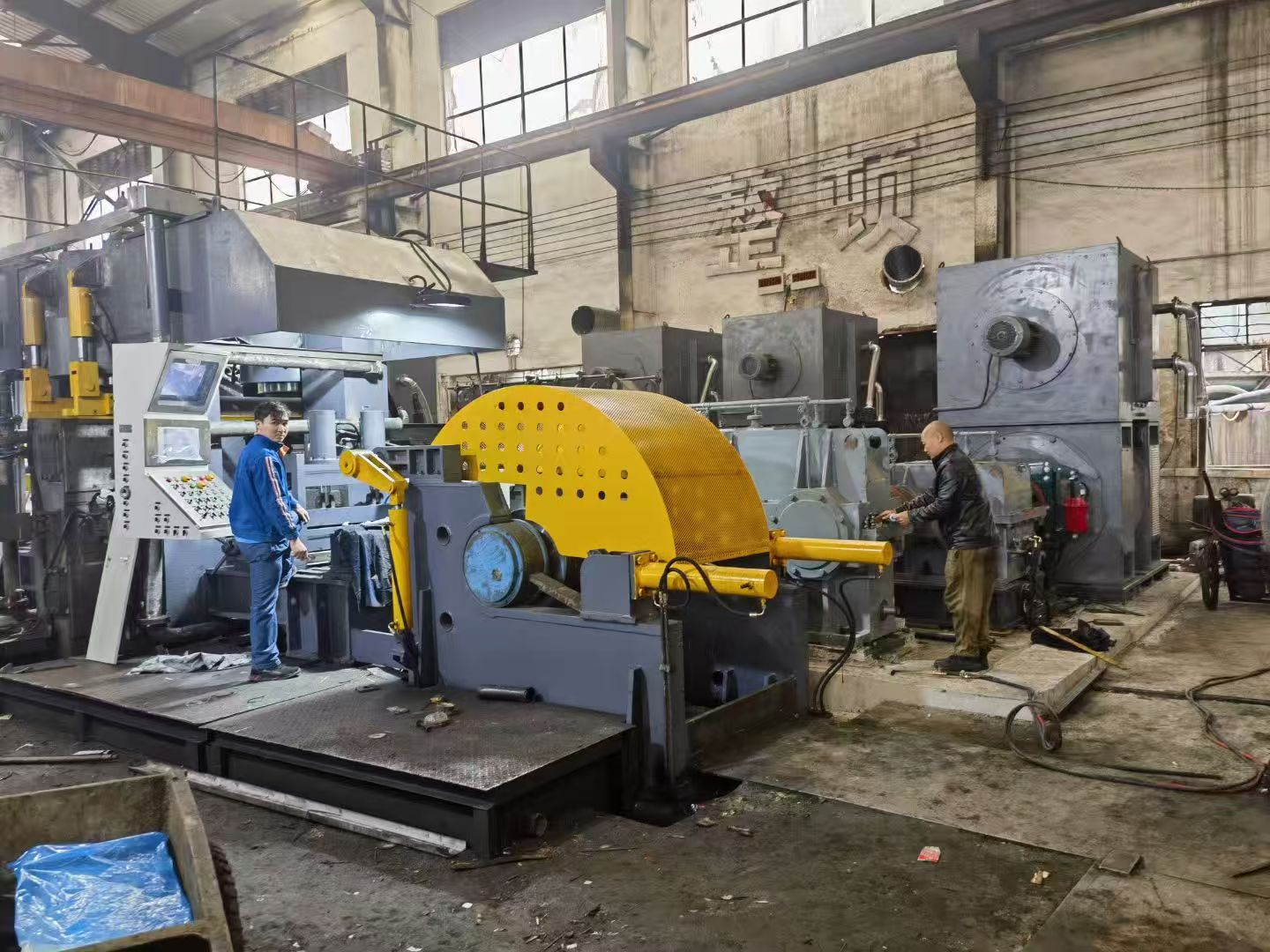 Workers operating equipment on the factory production floor